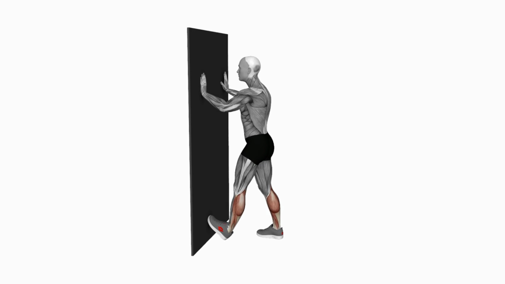 Person doing Calf Push Stretch with hands against wall for flexibility.